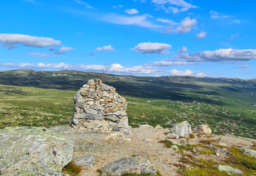 Stone cairn at the top of Djupegrønuten – reward of the mountain hike Dagali